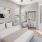 a bedroom with a large bed and a fan
