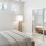 a bedroom with a bed and a lamp