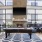 a room with a fireplace and chairs and a pool table