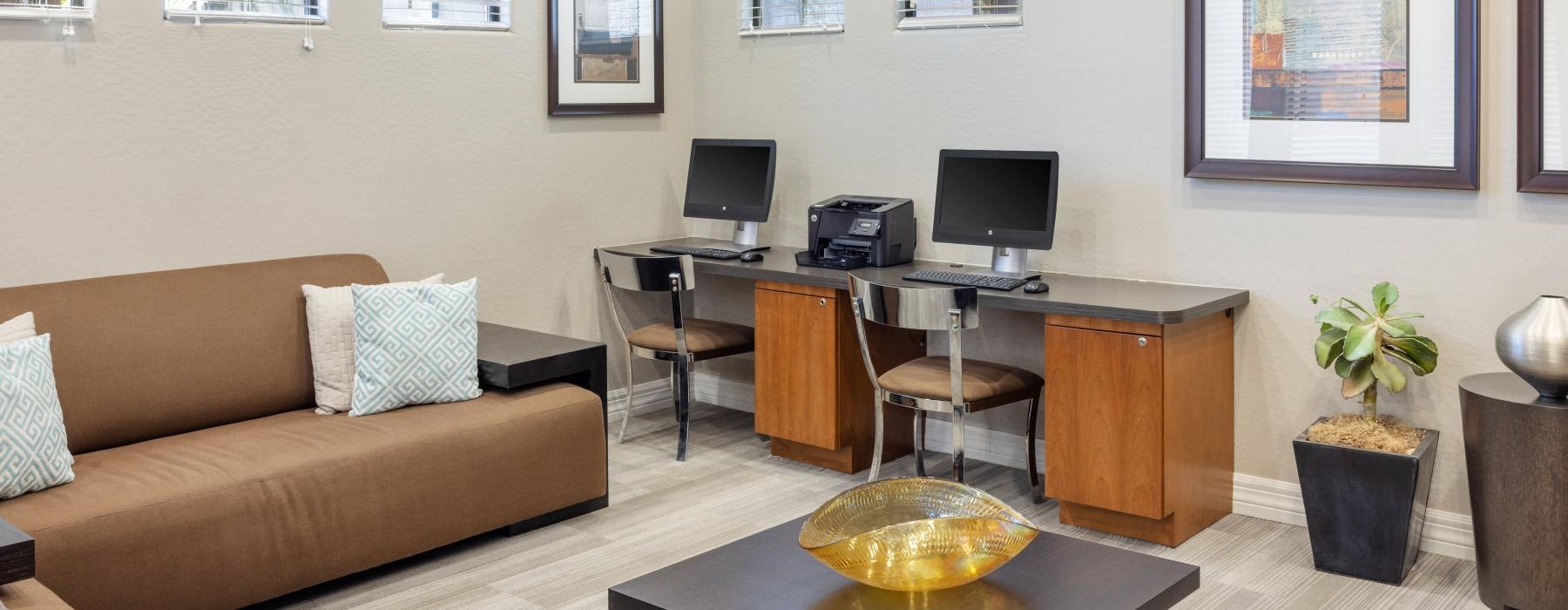 business center with couch, computers and printer