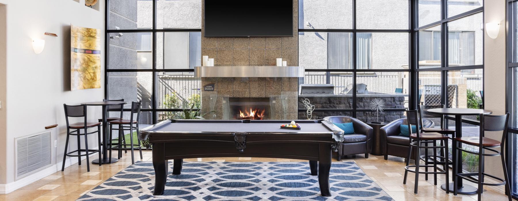 community clubhouse space with pool table near fireplace 