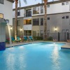 Resort-style swimming pool with lounge seating